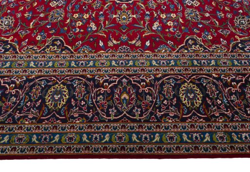 Corner detail of 2000s Kashan rug showing border pattern and Wool pile