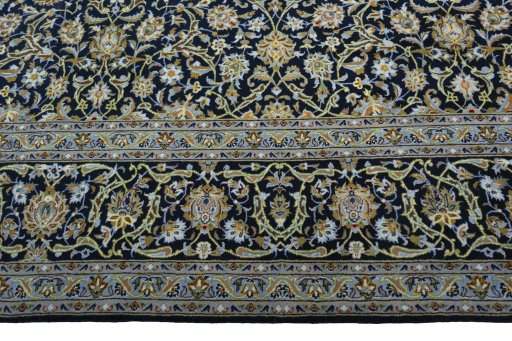 Corner detail of 2000s Kashan rug showing border pattern and Cork pile