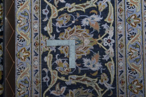 Backside of handmade 2000s Kashan rug showing knot structure and weave density