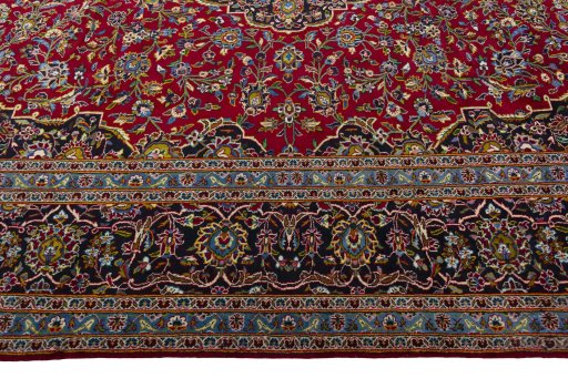 Corner detail of 2000s Kashan rug showing border pattern and Wool pile