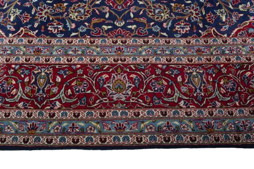 Corner detail of 2000s Kashan rug showing border pattern and Wool pile