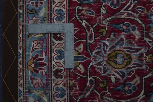 Backside of handmade 2000s Kashan rug showing knot structure and weave density
