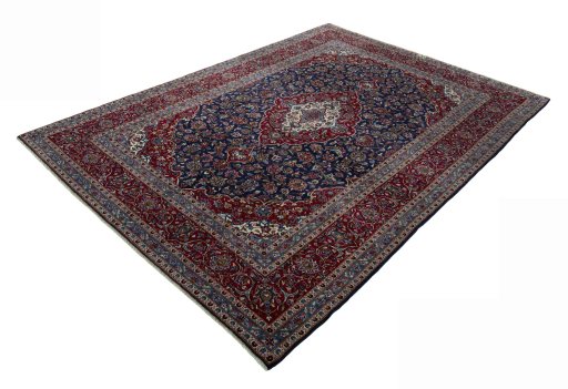 Corner detail of 2000s Kashan rug showing border pattern and Wool pile