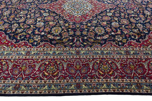 Corner detail of 2000s Kashan rug showing border pattern and Wool pile