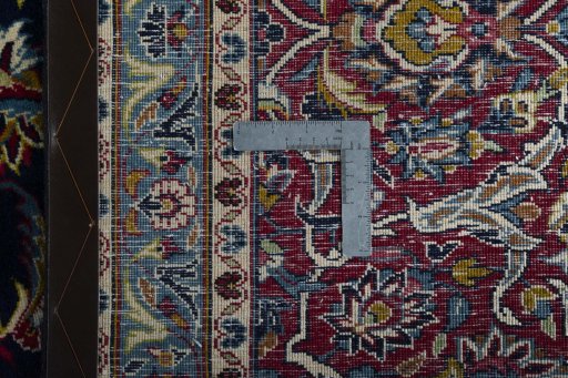 Backside of handmade 2000s Kashan rug showing knot structure and weave density