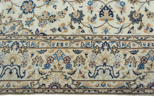 Corner detail of 2000s Kashan rug showing border pattern and Wool pile