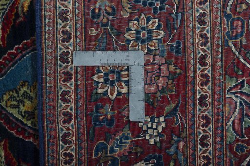Backside of handmade 1930s Kashan rug showing knot structure and weave density