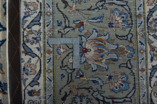 Backside of handmade 2000s Kashan rug showing knot structure and weave density