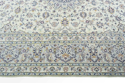 Corner detail of 2000s Kashan rug showing border pattern and Wool pile