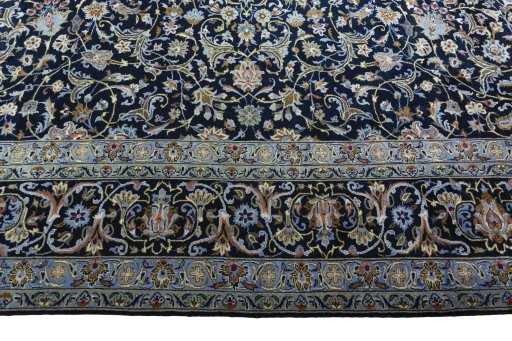 Corner detail of 2000s Kashan rug showing border pattern and Wool pile