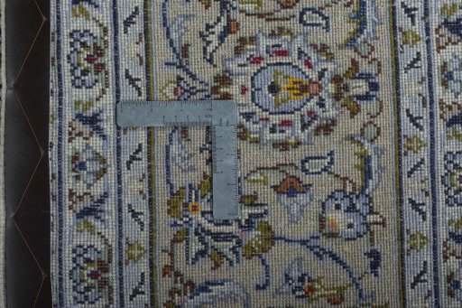 Backside of handmade 2000s Kashan rug showing knot structure and weave density