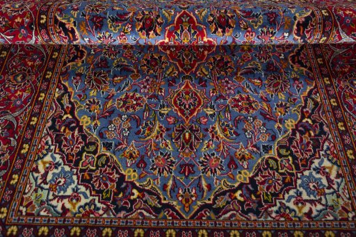 Corner detail of 2000s Kashan rug showing border pattern and Wool pile
