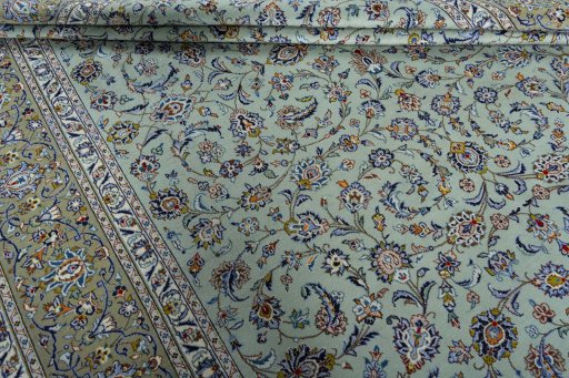 Corner detail of 2000s Kashan rug showing border pattern and Wool pile