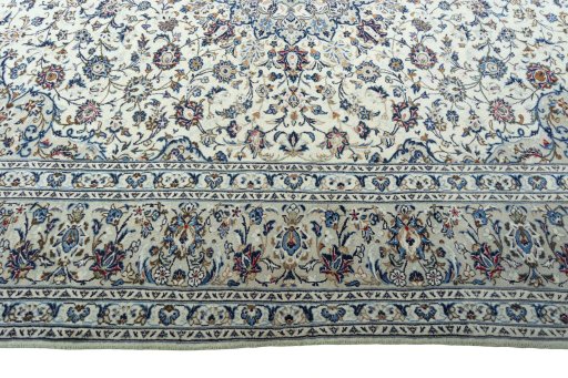 Corner detail of 2000s Kashan rug showing border pattern and Wool pile