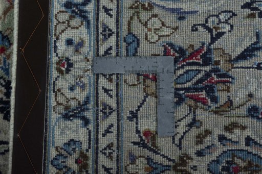 Backside of handmade 2000s Kashan rug showing knot structure and weave density