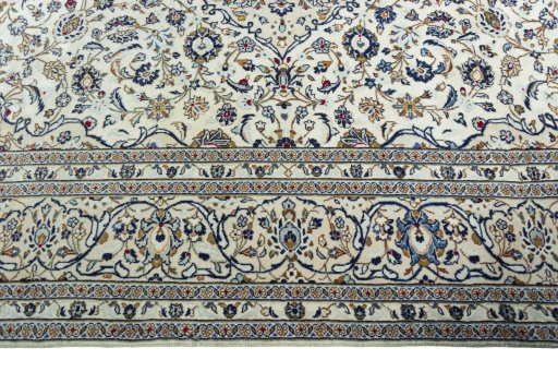 Corner detail of 2000s Kashan rug showing border pattern and Wool pile