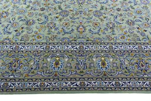 Corner detail of 2000s Kashan rug showing border pattern and Wool pile