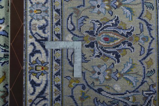 Backside of handmade 2000s Kashan rug showing knot structure and weave density