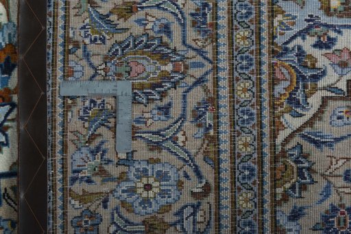 Backside of handmade 2000s Kashan rug showing knot structure and weave density