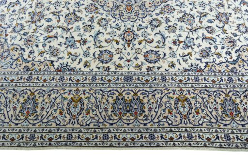 Corner detail of 2000s Kashan rug showing border pattern and Wool pile