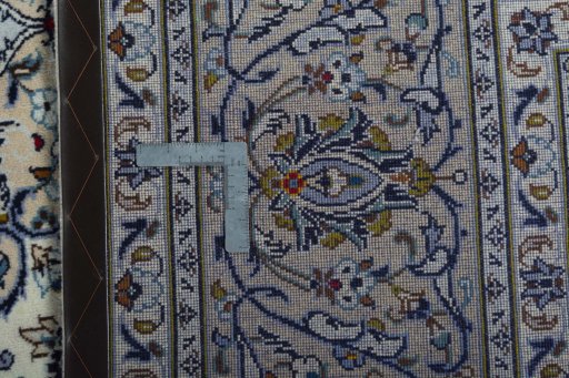 Backside of handmade 2000s Kashan rug showing knot structure and weave density