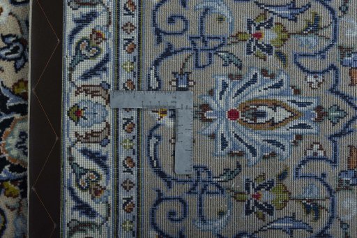 Backside of handmade 2000s Kashan rug showing knot structure and weave density