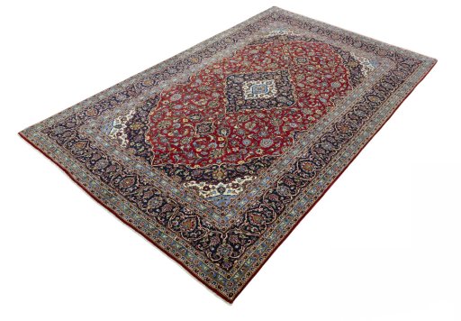 Corner detail of 2000s Kashan rug showing border pattern and Cork pile