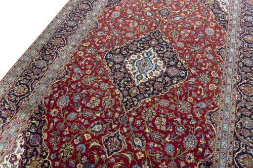 Backside of handmade 2000s Kashan rug showing knot structure and weave density