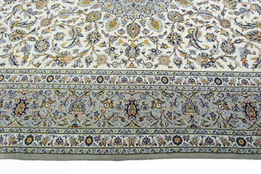 Corner detail of 2000s Kashan rug showing border pattern and Wool pile