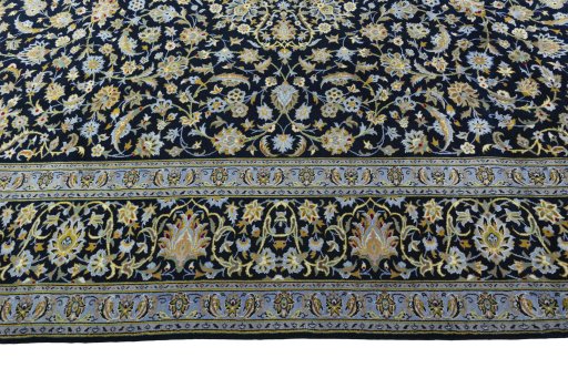 Corner detail of 2000s Kashan rug showing border pattern and Wool pile