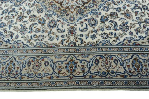 Corner detail of 2000s Kashan rug showing border pattern and Wool pile
