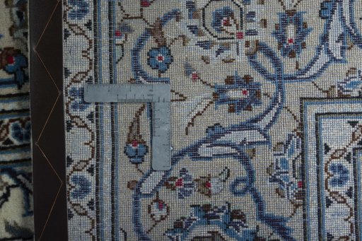 Backside of handmade 2000s Kashan rug showing knot structure and weave density