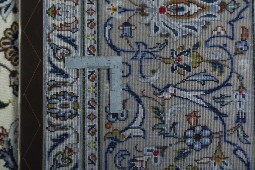 Backside of handmade 2000s Kashan rug showing knot structure and weave density