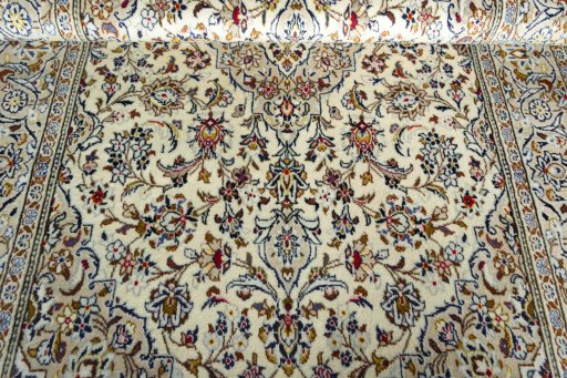Corner detail of 2000s Kashan rug showing border pattern and Wool pile