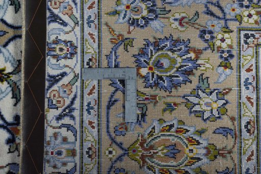 Backside of handmade 2000s Kashan rug showing knot structure and weave density