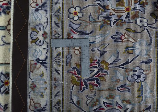 Backside of handmade 2000s Kashan rug showing knot structure and weave density