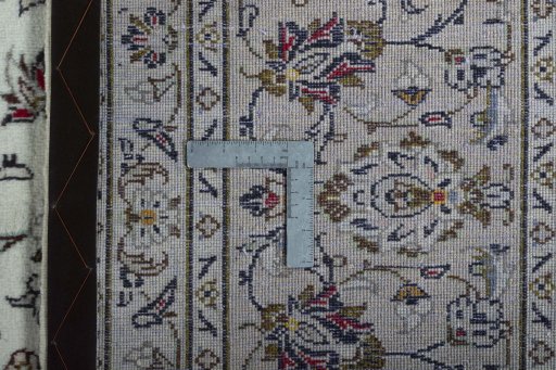 Backside of handmade 2000s Kashan rug showing knot structure and weave density