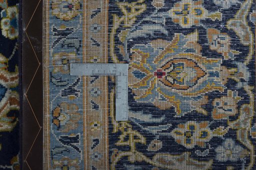 Backside of handmade 2000s Kashan rug showing knot structure and weave density