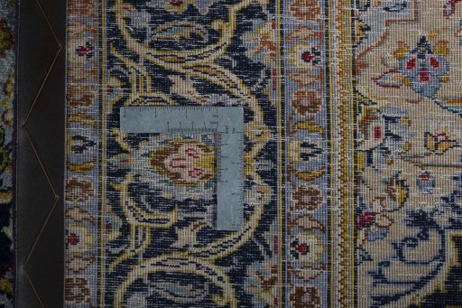 Backside of handmade 1970s Kashan rug showing knot structure and weave density