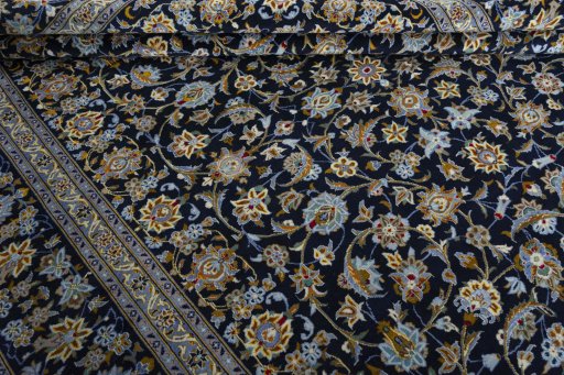 Close-up detail of 2000s Kashan rug from Iran / Persia showing Wool weave