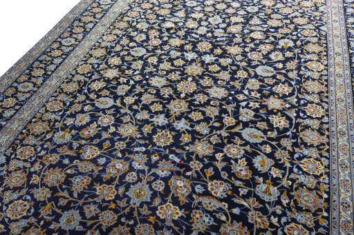Backside of handmade 2000s Kashan rug showing knot structure and weave density