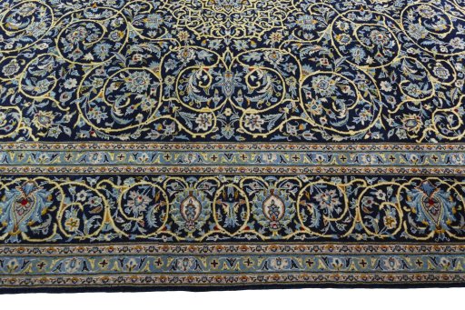 Corner detail of 2000s Kashan rug showing border pattern and Wool pile