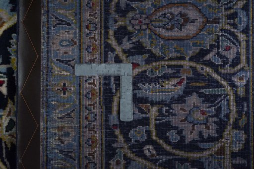 Backside of handmade 2000s Kashan rug showing knot structure and weave density
