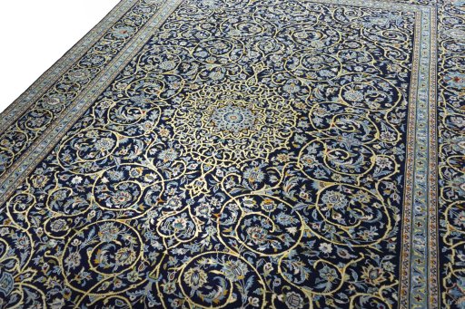 Backside of handmade 2000s Kashan rug showing knot structure and weave density