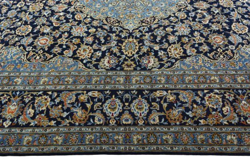 Corner detail of 2000s Kashan rug showing border pattern and Wool pile