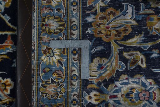 Backside of handmade 2000s Kashan rug showing knot structure and weave density