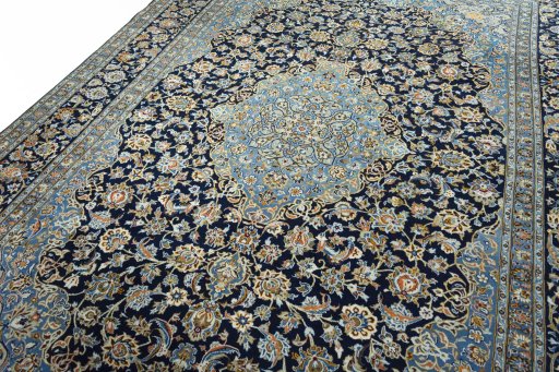 Backside of handmade 2000s Kashan rug showing knot structure and weave density