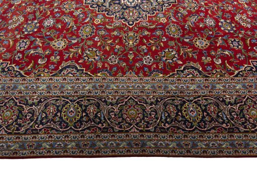 Corner detail of 2000s Kashan rug showing border pattern and Wool pile