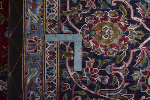 Backside of handmade 2000s Kashan rug showing knot structure and weave density