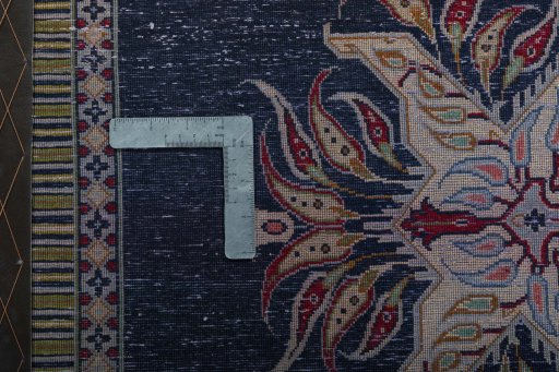 Backside of handmade 2000s Kashan rug showing knot structure and weave density